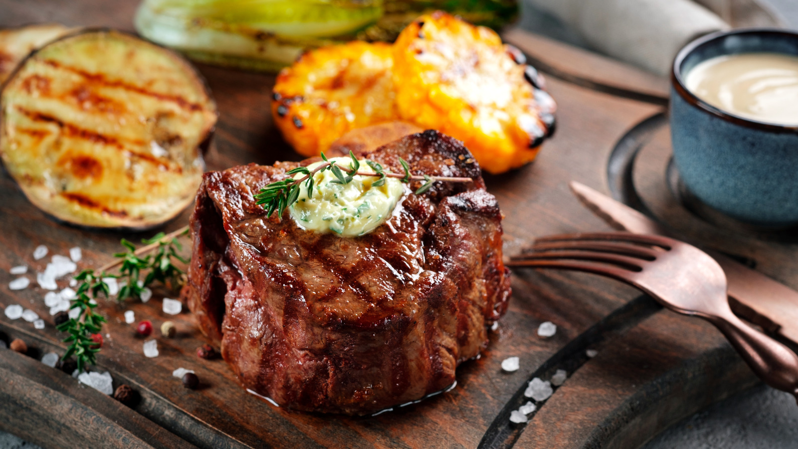 Grilled,Beef,Tenderloin,Steak,On,A,Wooden,Board,With,Butter